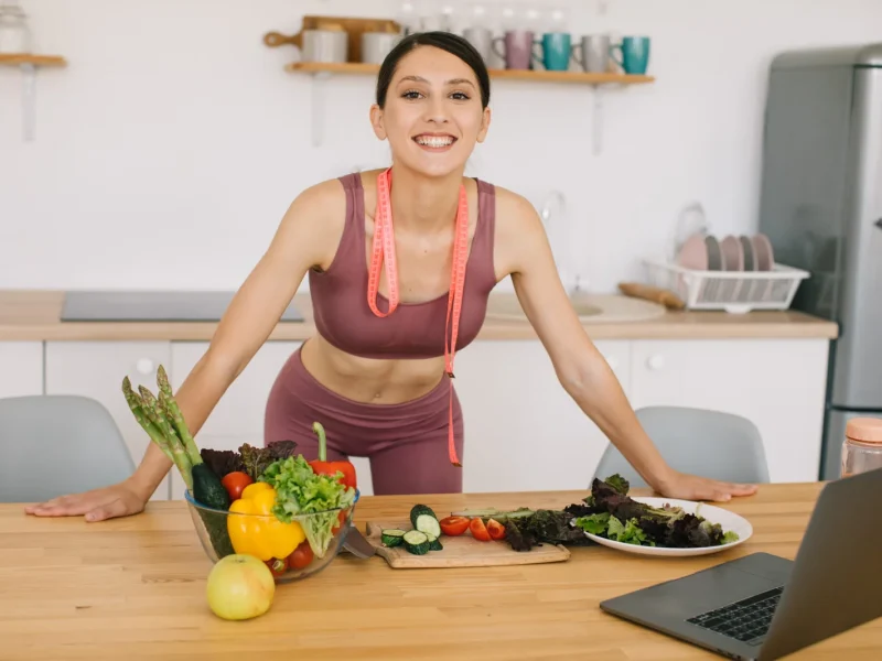 portrait-sporty-woman-blogger-leading-video-conference-healthy-eating-laptop-kitchen-2048x1365