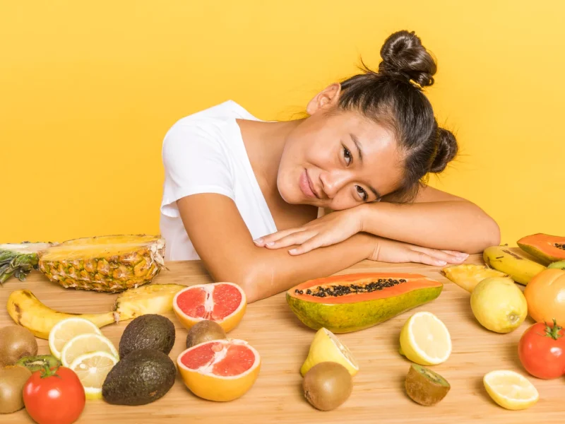 woman-looking-camera-surrounded-by-fruits-2048x1365