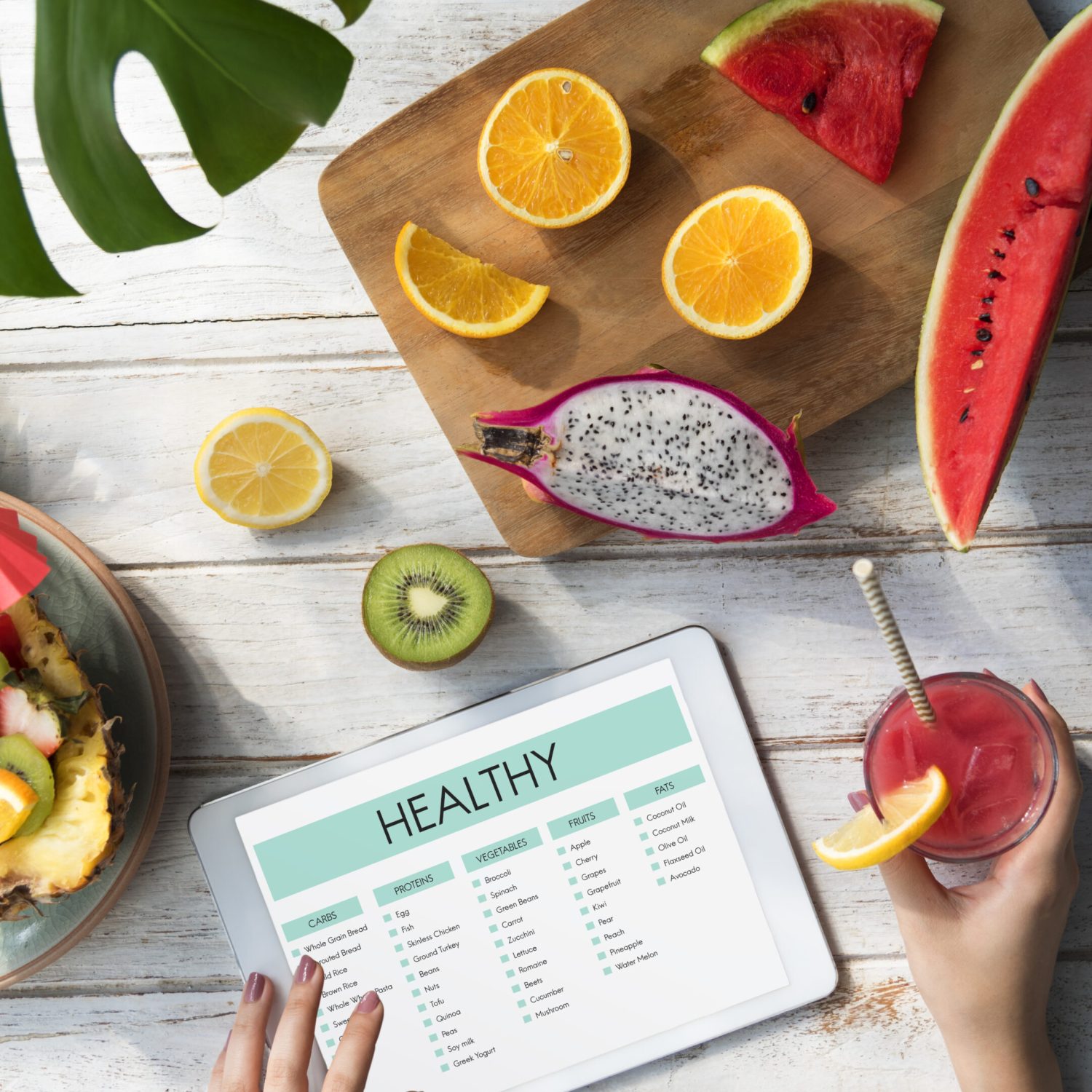 woman-using-tablet-with-summer-fruit-flat-lay (1)